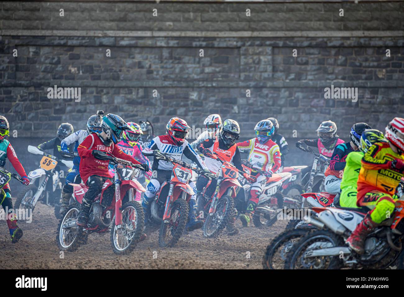 Weston-super-Mare, Somerset, England, UK. 12th October, 2024,  Riders rounding the first corner in the 125cc/250cc class on day 1 of the 2024 ROKIT Weston Beach Race. This year marks the 41st anniversary of the prestigious Weston Beach Race and it promises to be a spectacular event celebrating over four decades of off-road excellence. Credit John Rose/Alamy Live News Stock Photo