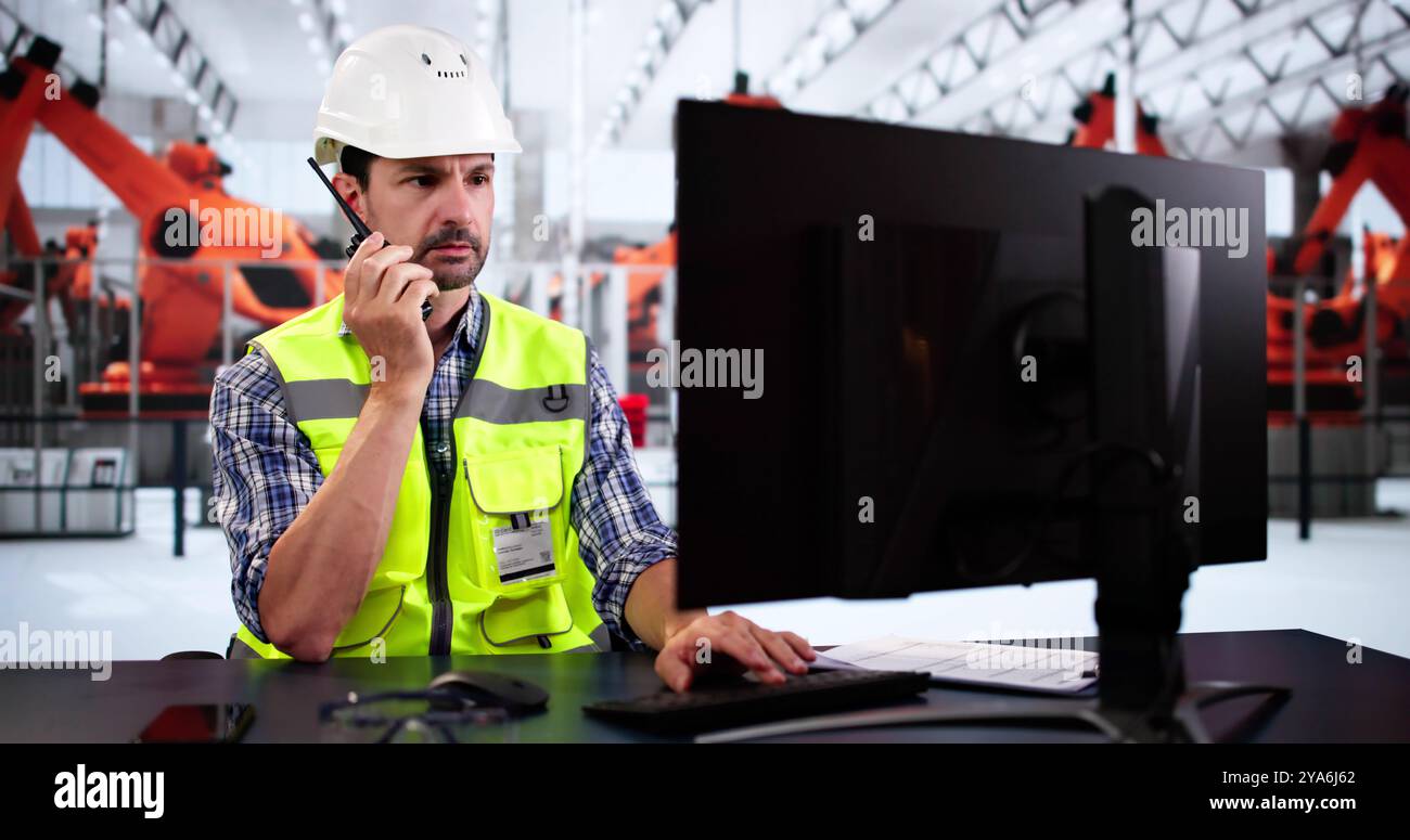Automobile Vehicle Production Worker Using Walkie Talkie Stock Photo
