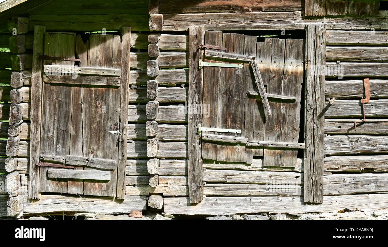 Old barn with crooked wooden door and window shutter, Lauterbrunnen valley, Bernese Oberland, Switzerland Stock Photo