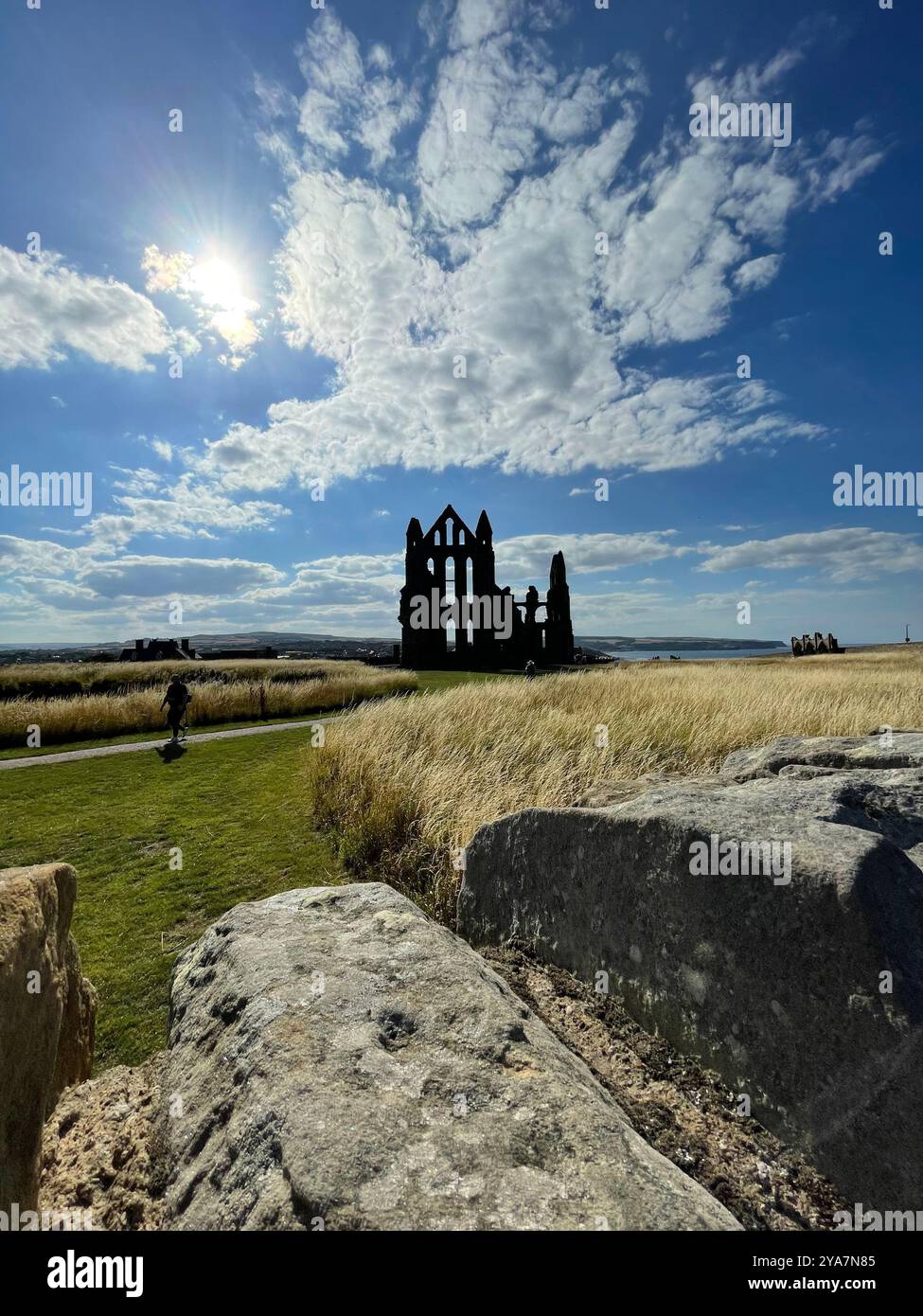 “Silhouetted against a dramatic sky, the ancient ruins stand proudly amidst the windswept fields.” - Smartphone Captured Stock Image