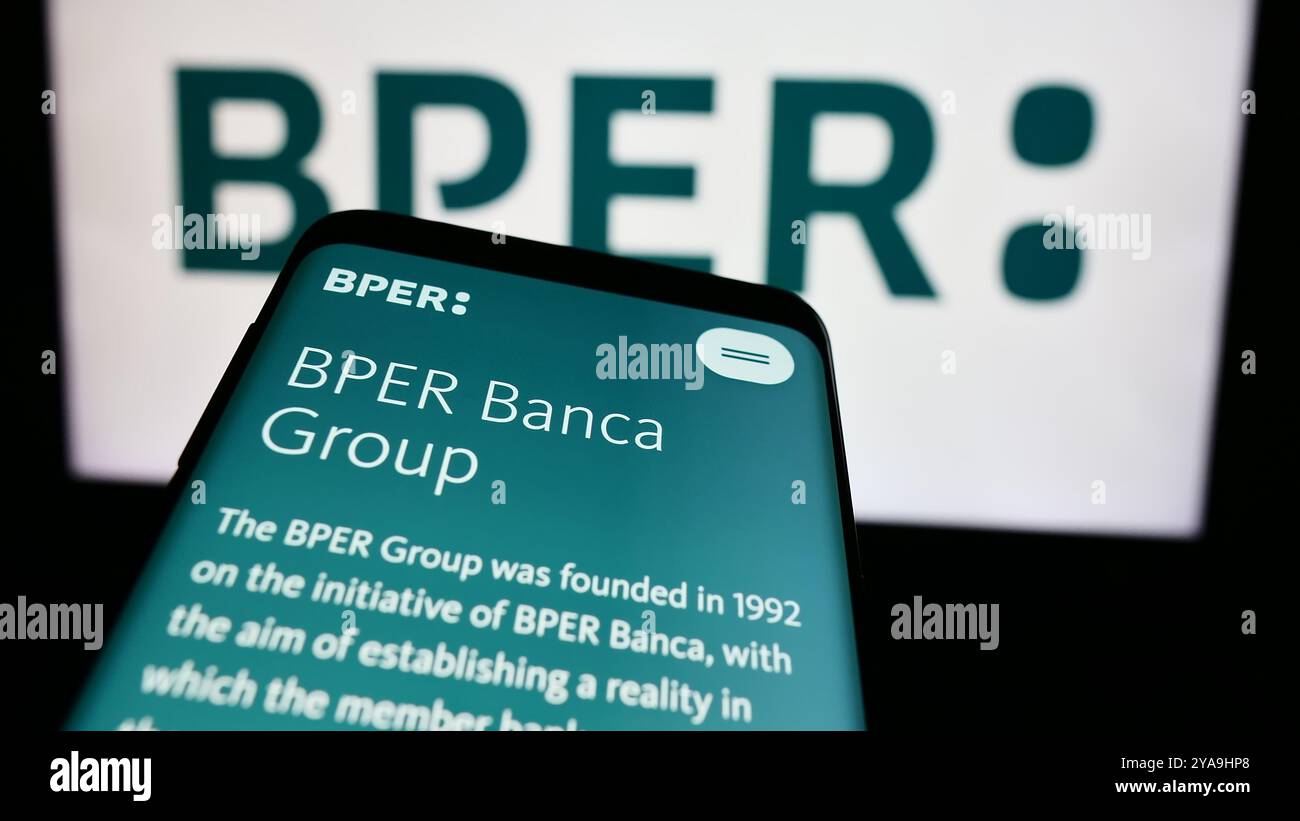 In this photo illustration, a smartphone with the webpage of Italian financial services company BPER Banca S.p.A. is seen in front of business logo. Stock Photo