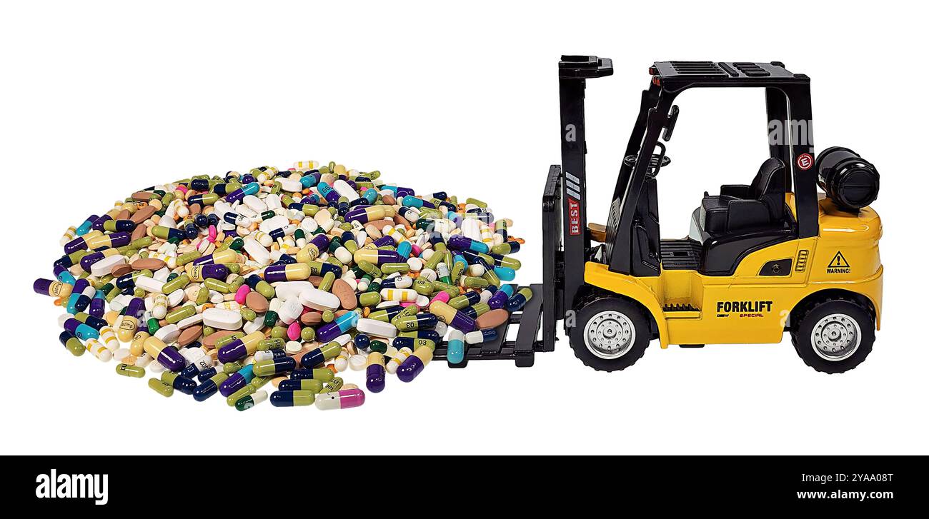 A yellow forklift scooping a pile of medical pills to show drug trafficking Stock Photo