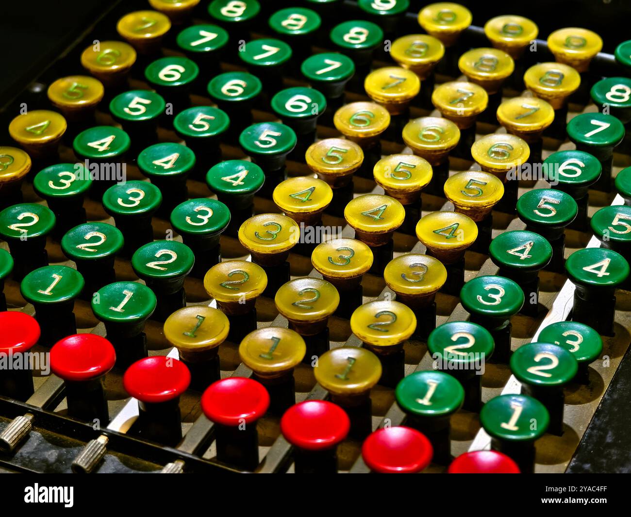 An old fashioned adding machine features a drawer located underneath it Stock Photo