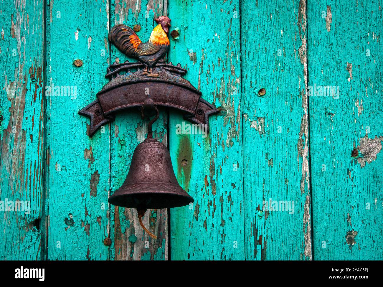 Close up photography of a rustic cast iron rooster plaque with bell ...