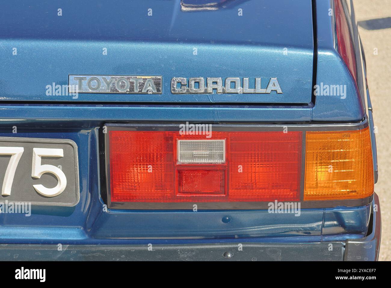 Close up of the rear end of a blue toyota corolla, highlighting its classic design and iconic logo Stock Photo