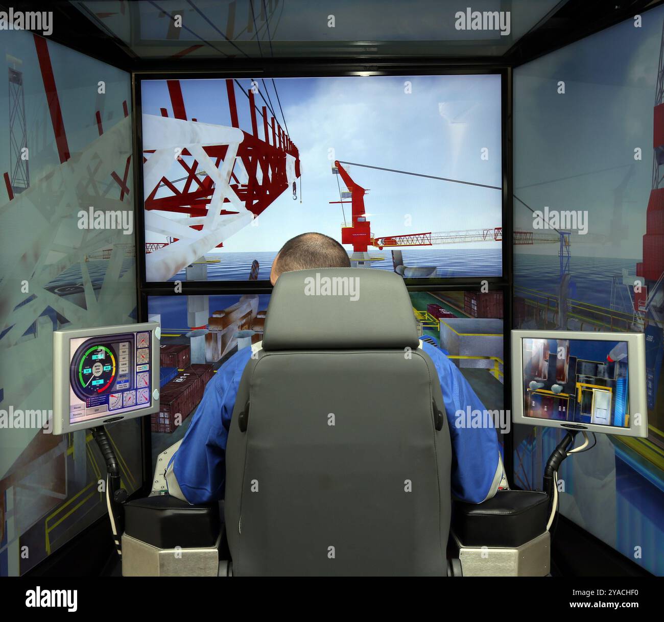 Worker in a crane simulator Stock Photo