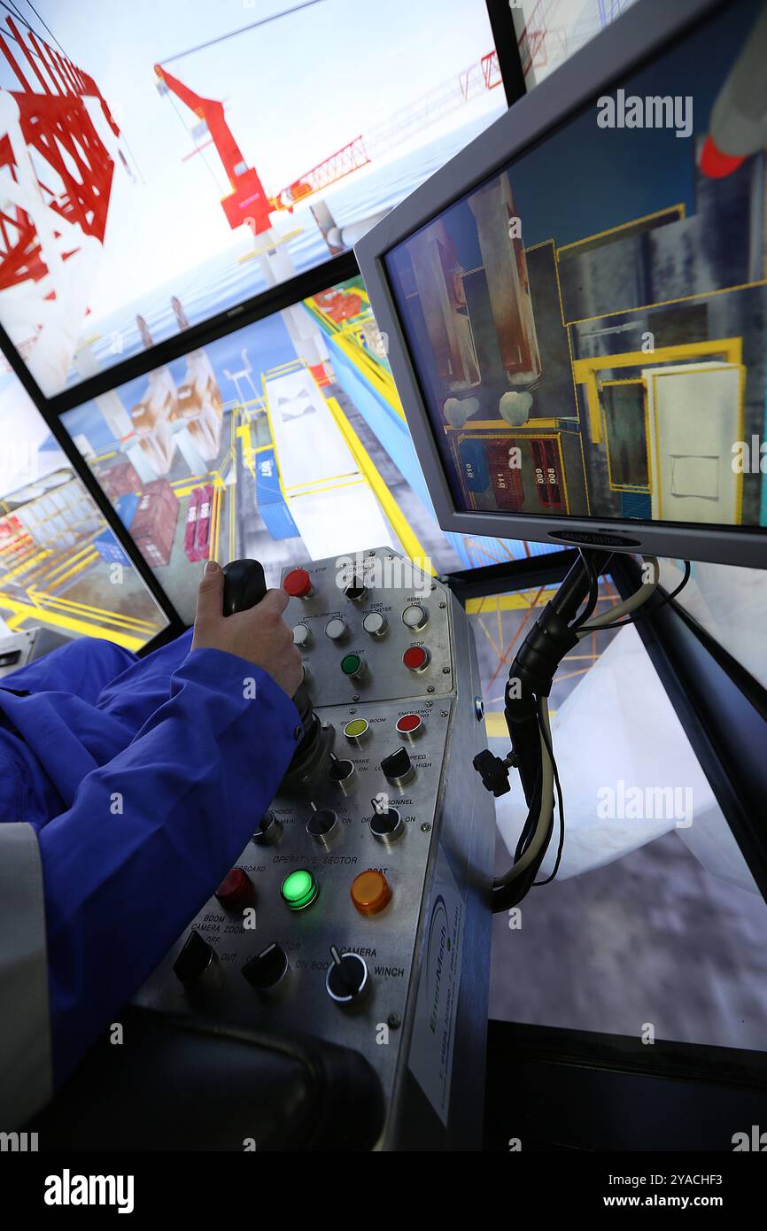 Worker in a crane simulator Stock Photo