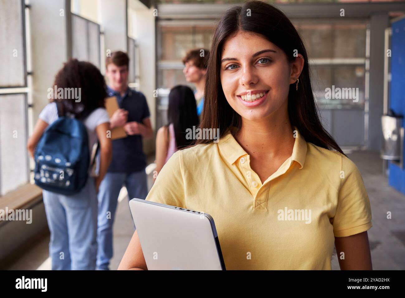 Happy portrait of a female high school student looking at camera ...