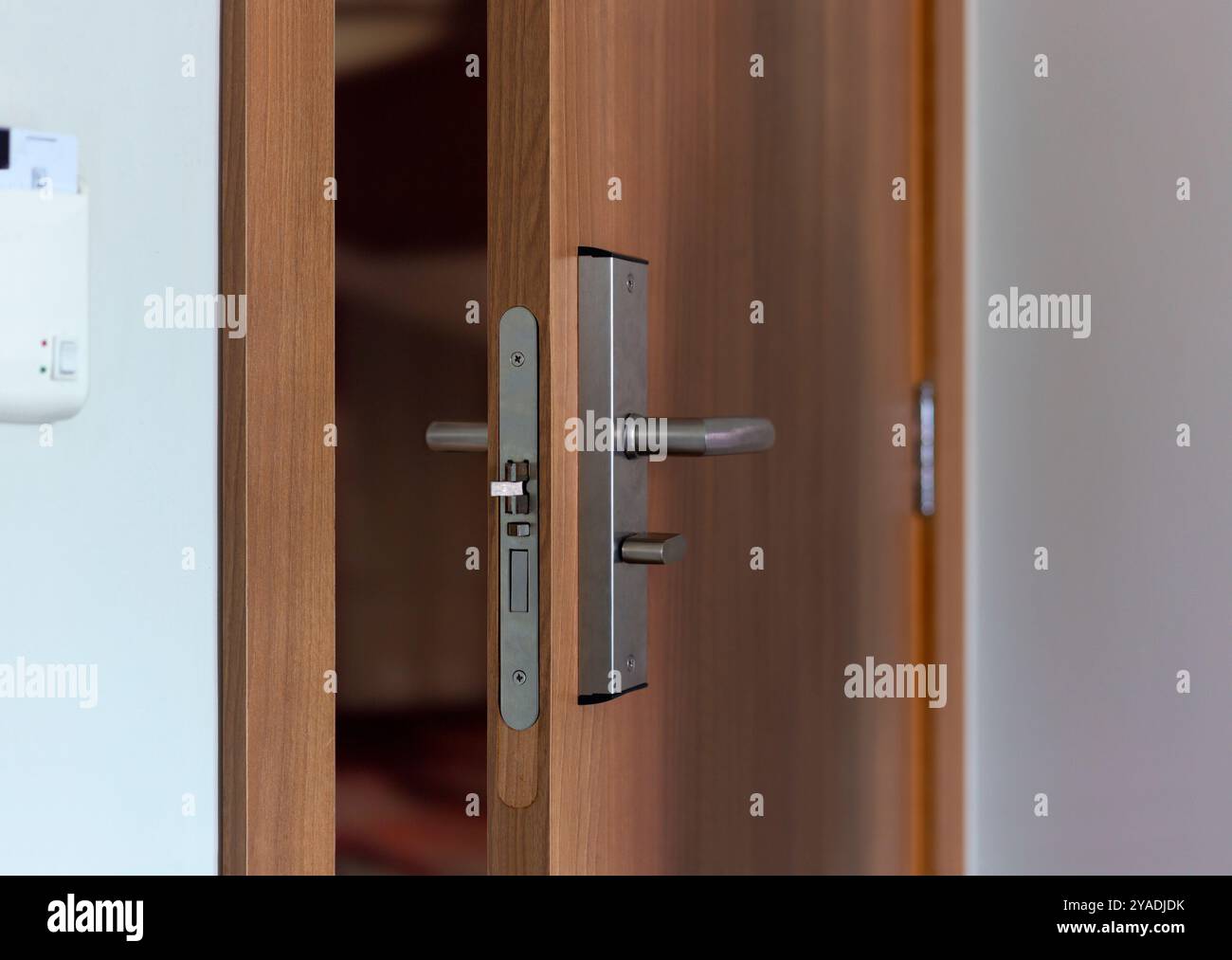 Wooden door with electronic lock. Entrance door with electronic keycard lock system. Close up view. Stock photo in vertical format. Stock Photo