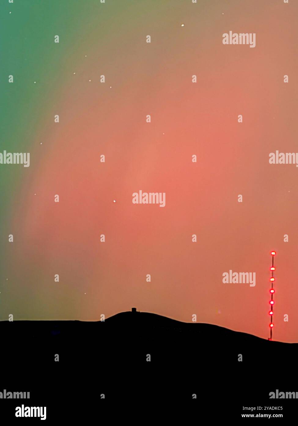 Aurora Borealis (Northern Lights) over Rivington near Chorley in Lancashire. Also showing lights from Rivington festival of light. - Smartphone Captured Stock Image