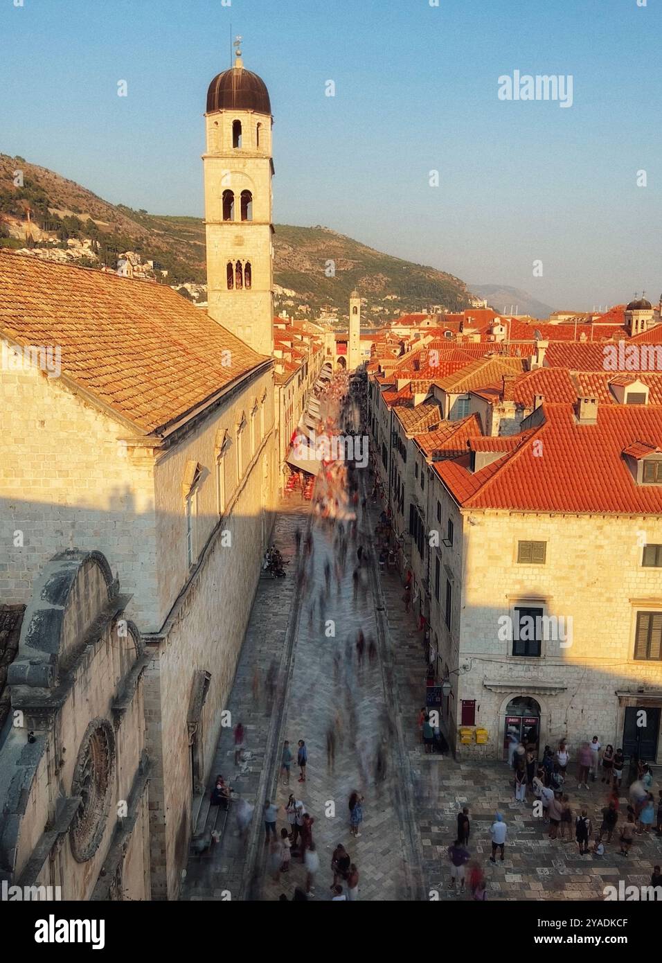 Stradun (Placa) in Dubrovnik old town. Looking down street from city walls towards bell tower in evening light. Dubrovnik, Croatia - Smartphone Captured Stock Image Stradun (Placa) in Dubrovnik old town. Looking down street from city walls towards bell tower in evening light. Dubrovnik, Croatia - Smartphone Captured Stock Image