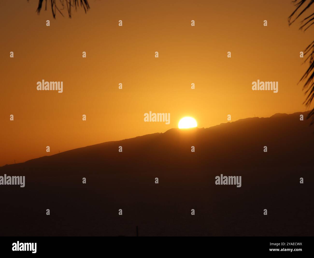 Sun going down over the mountain Stock Photo
