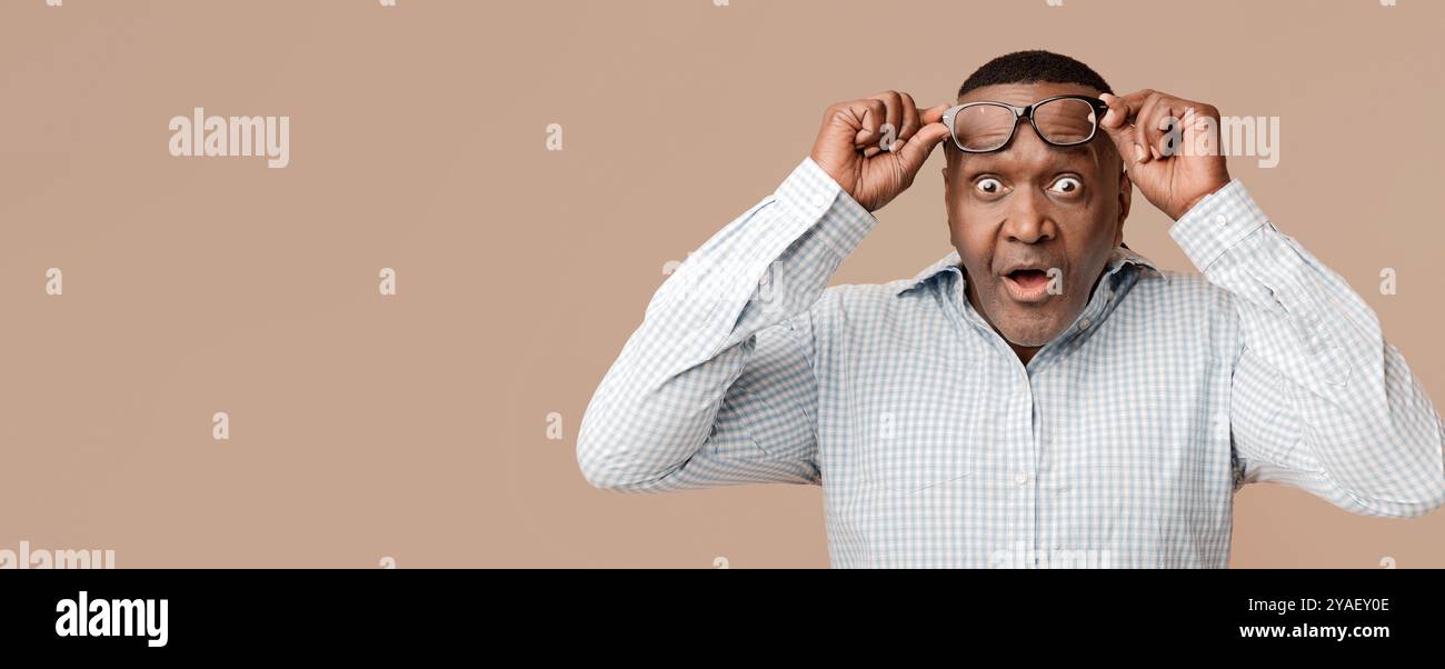Shocked mature african american man looking at camera Stock Photo - Alamy