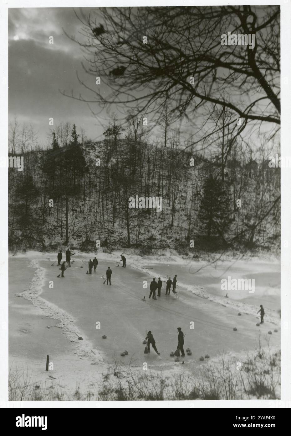 Group of people play curling outdoors on frozen pond in High Park, Toronto,  1912. Vintage Photograph Stock Photo