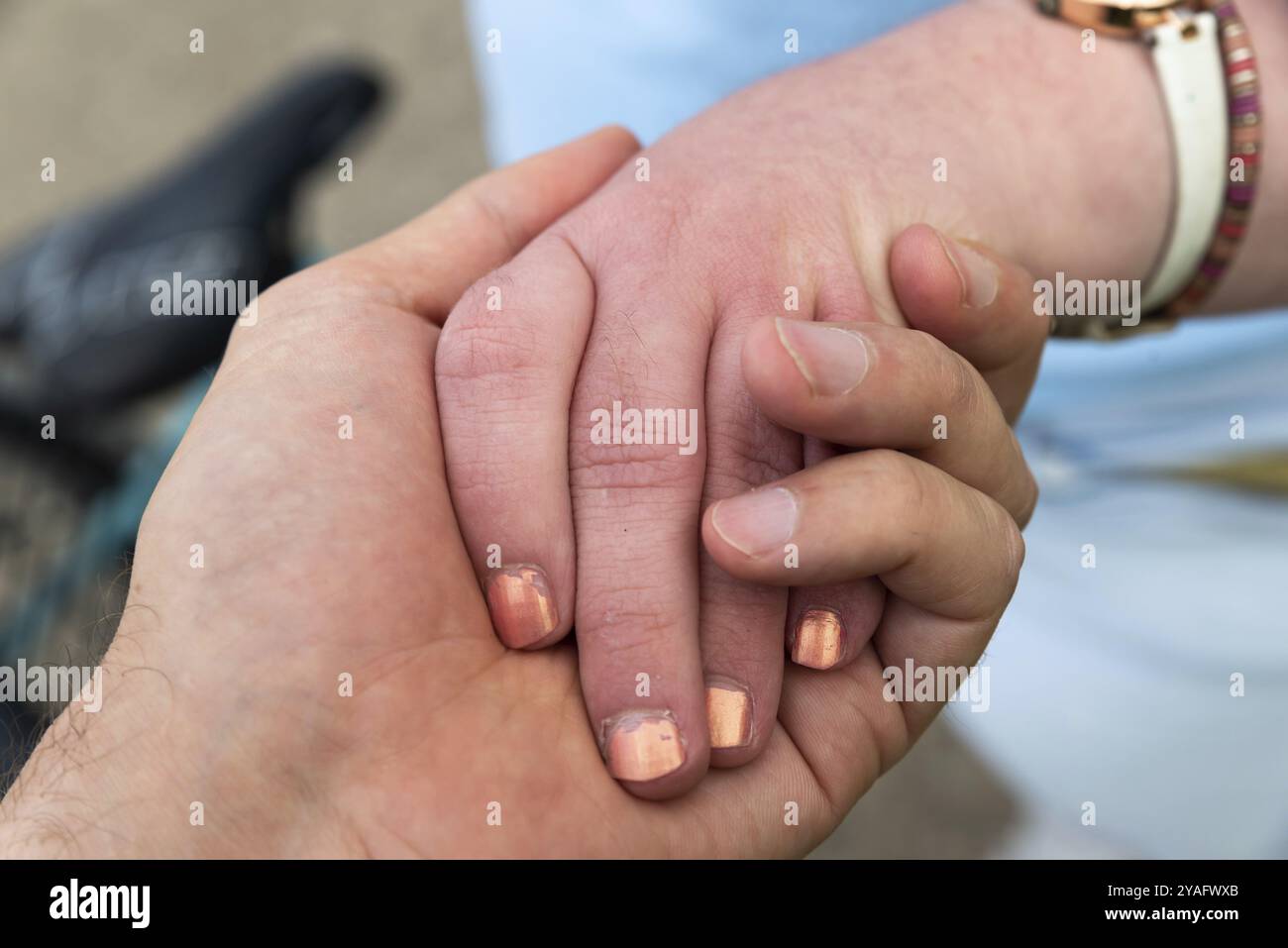 Close up of the hands of a 39 year old woman with Down Syndrome and her non disabled brother of 42 years old Stock Photo