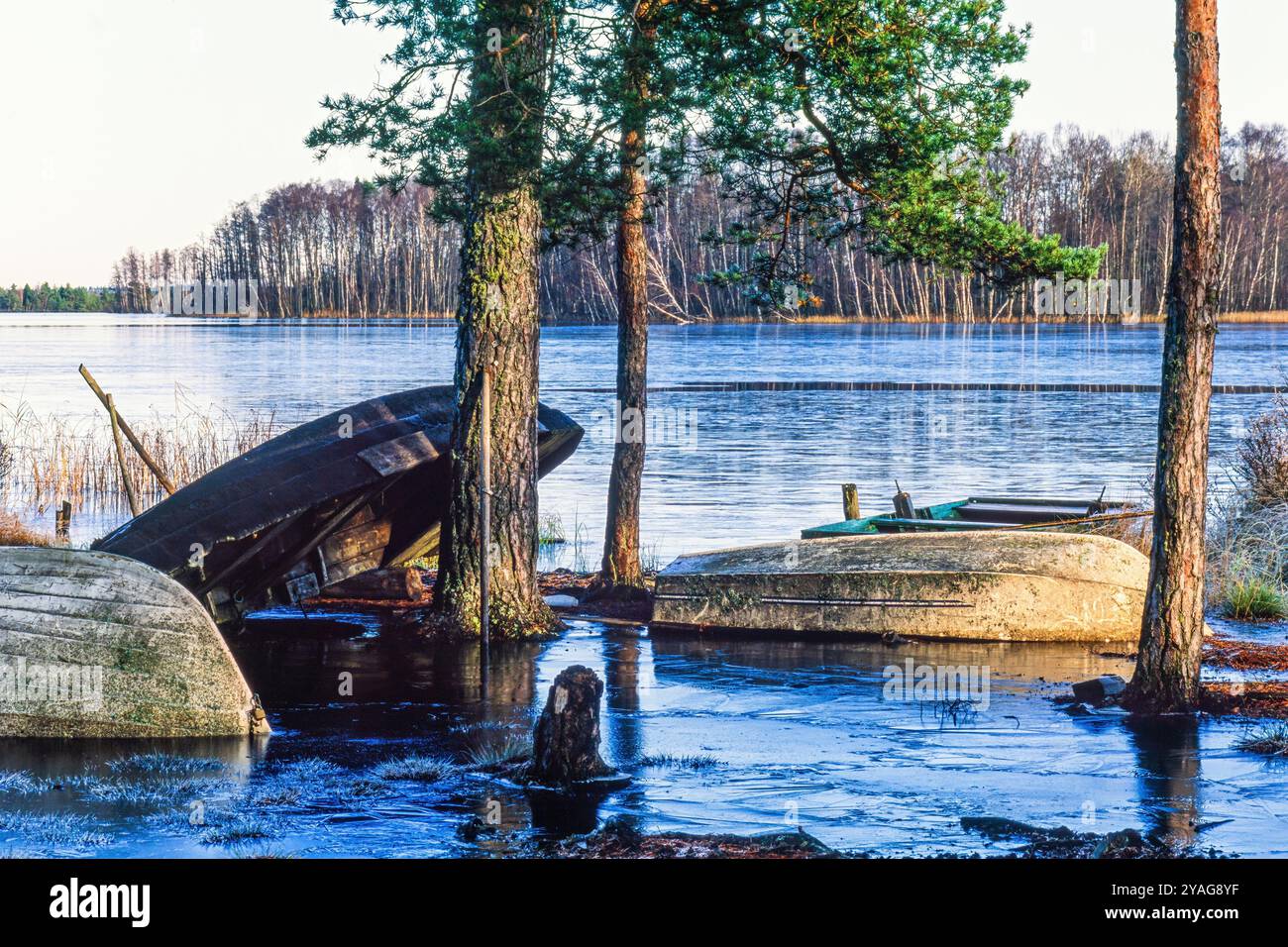 Frozen water on a beach with rowing boats Stock Photo - Alamy