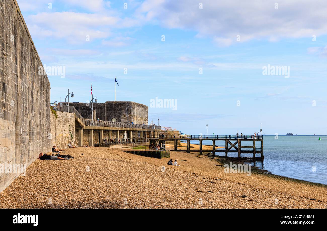 The shingle beach at Hotwalls, Portsmouth City Wall, Victoria Pier and view of the Solent at low tide in Old Portsmouth on the Nelson Trail, Hampshire Stock Photo