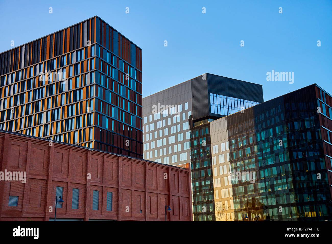 Modern glass office buildings reflecting city skyline in windows at ...