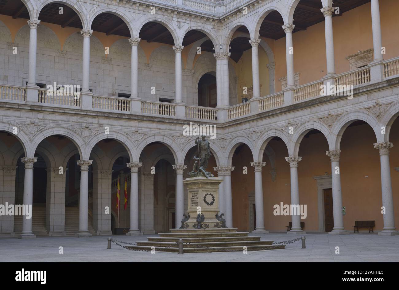 Alcázar of Toledo. Parade Ground, also known as Courtyard of Charles V. It features a square floor plan of portico galleries into two levels, with double arches supported by columns. In the centre of the courtyard there is a 19th century copy of the allegorical sculpture of 'Charles V Dominating Fury', the original of which, made by Leone and Pompeo Leoni, is on display in the Prado National Museum. The building was reconstructed after severe damage suffered during the Civil War (1936-1939). Castile-La Mancha. Spain. Stock Photo