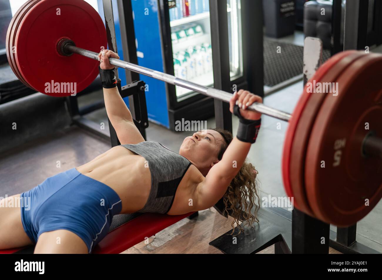 Middle aged woman doing bench press at the gym Stock Photo - Alamy