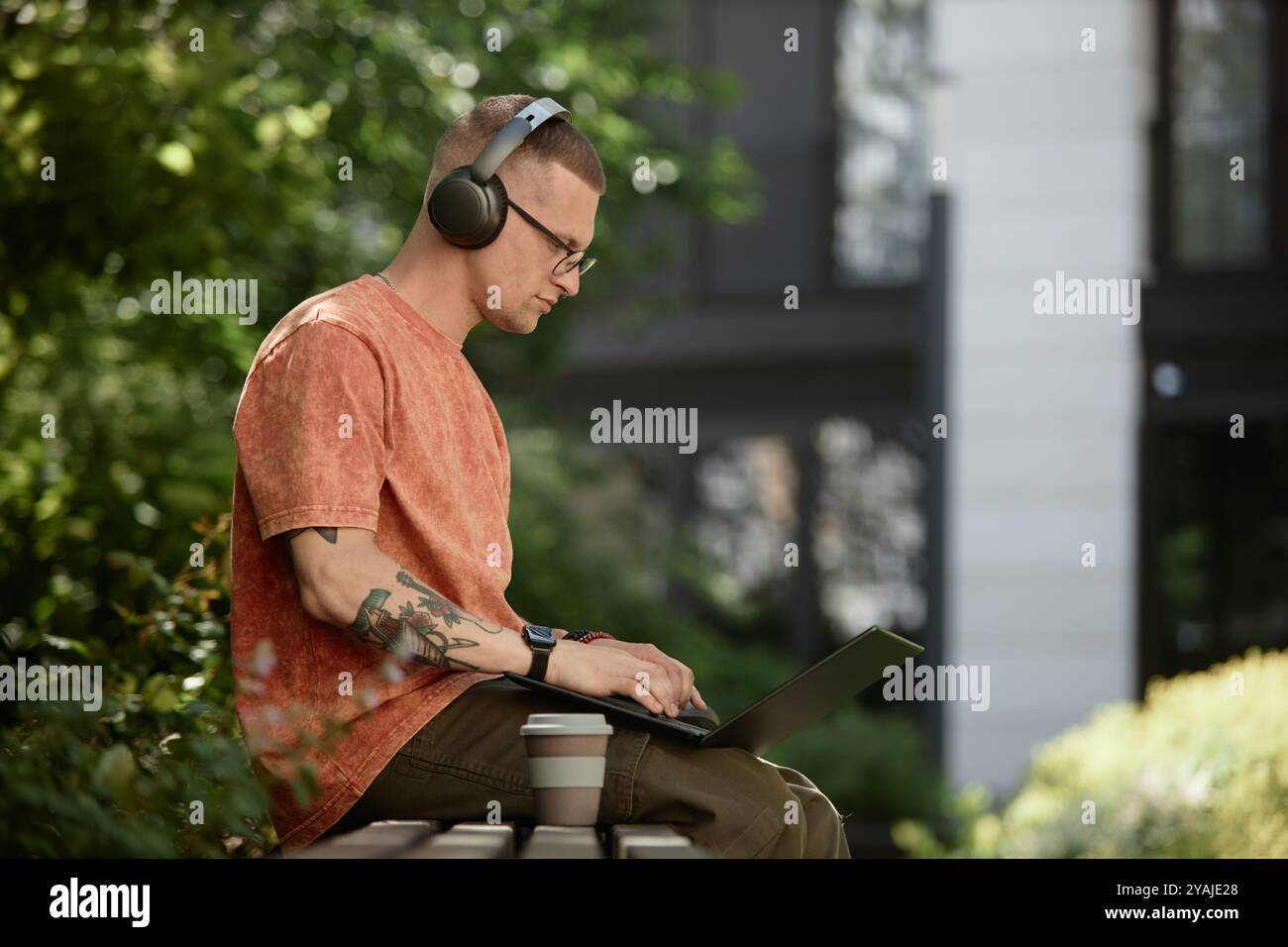 Medium shot of male IT developer concentrated on using laptop to write code Stock Photo
