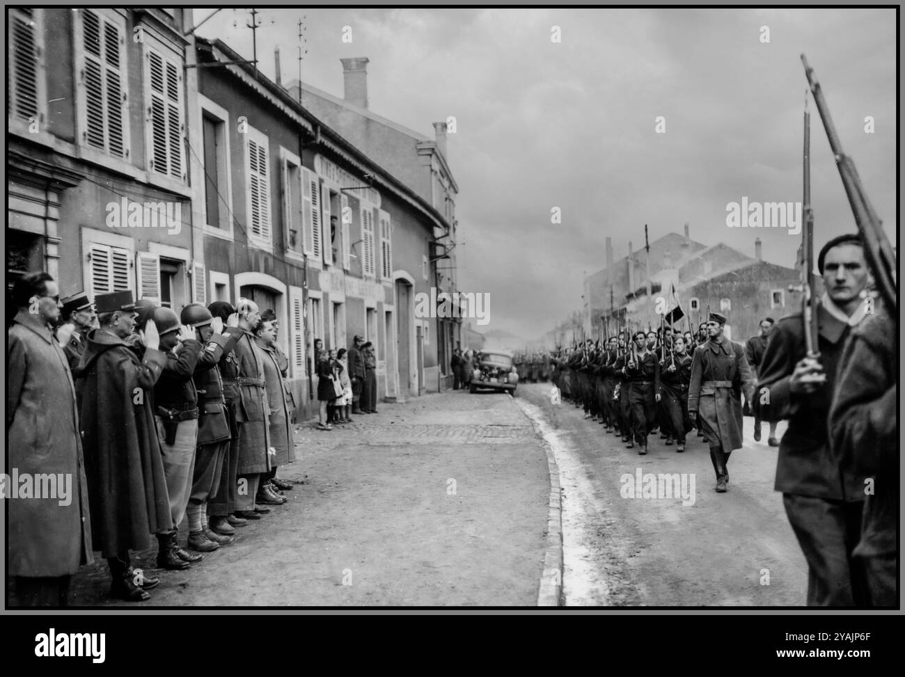 WW2 FRANCE ARMY MARCHING The first French regiment of Paris, France, recently organized and put in uniform, passes in review. 2 October, 1944.review parade on October 2, 1944, served as both a morale boost for the citizens of Paris and a demonstration of France's resurgence as a military power. French civilians, many of whom had resisted German occupation, celebrated the sight of their army marching once again through the streets of the capital and onwards.October 2, 1944, parade remains a memorable event in the history of France’s liberation. Stock Photo