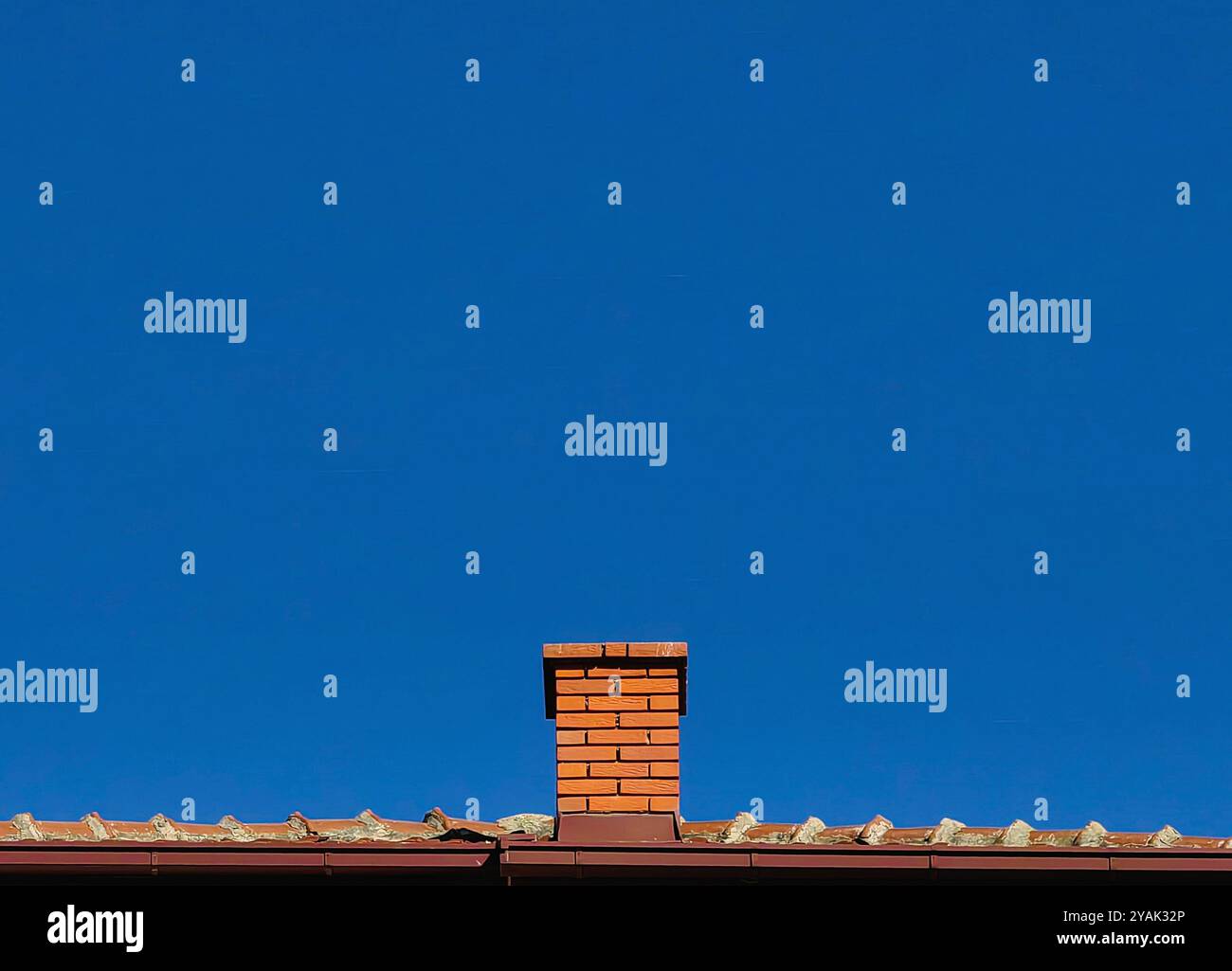 Brick Chimney Isolated on Clear Blue Sky Stock Photo