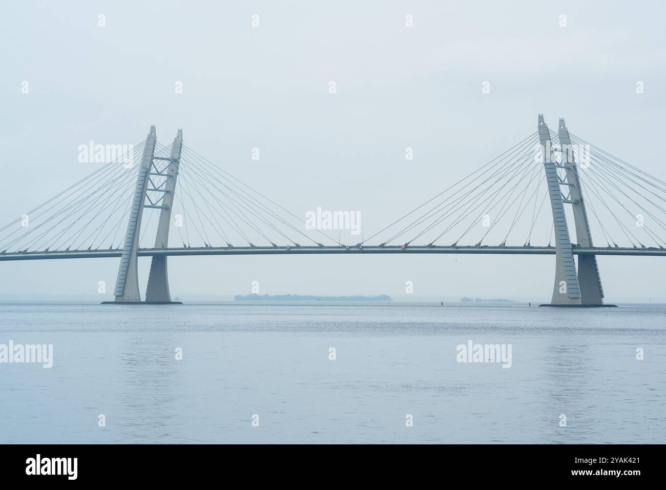 distant bridge over foggy bay on rainy day Stock Photo - Alamy