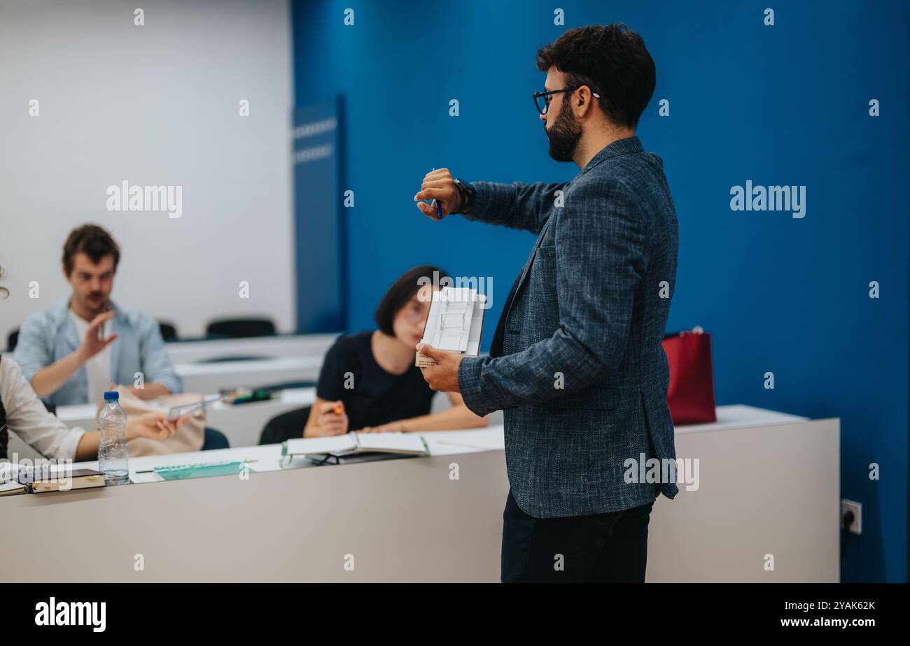 Professor assisting students during an engaging classroom session Stock Photo