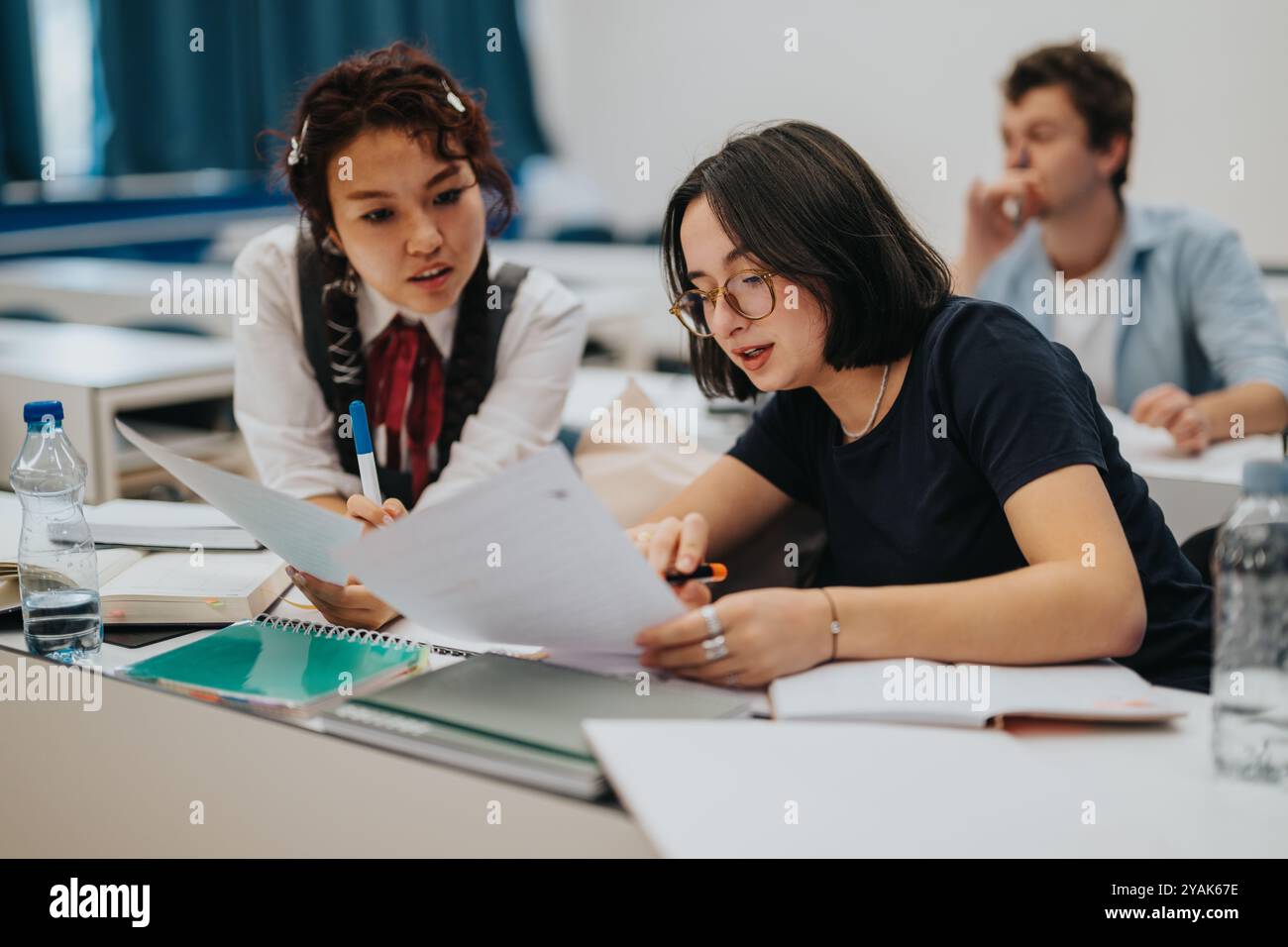Students engaging in collaborative learning during classroom session Stock Photo