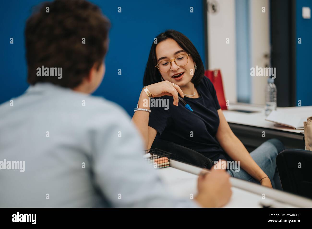 Engaged students in lively discussion during a classroom session Stock Photo