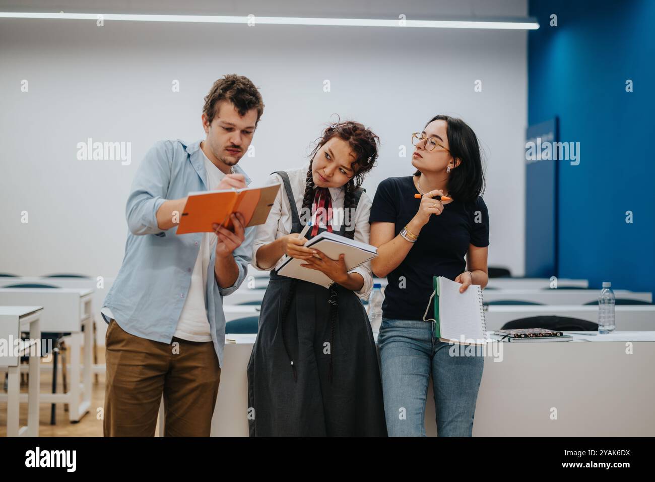 Group of students collaborating on a project in classroom Stock Photo