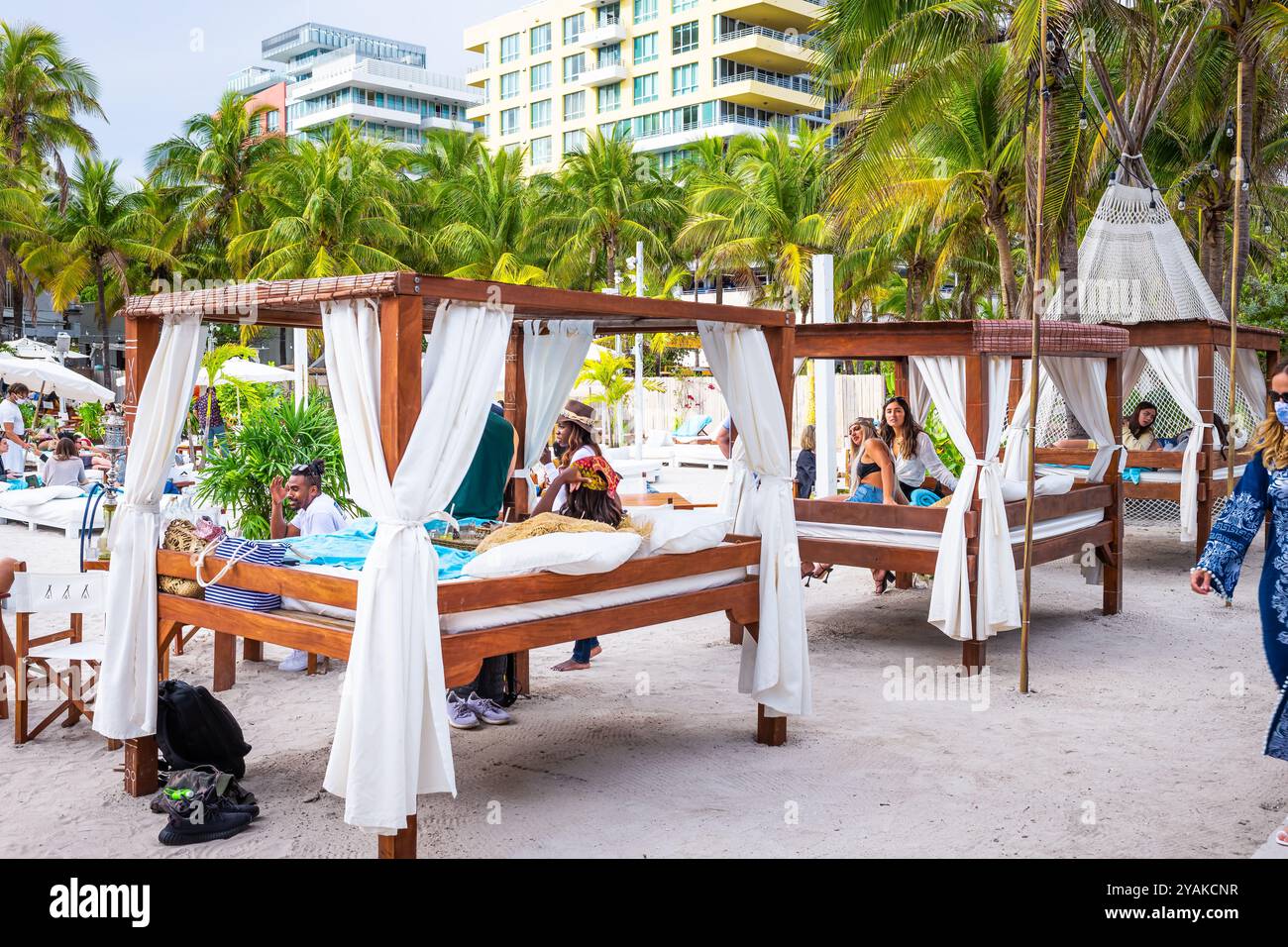 South Beach, USA - January 17, 2021: Nikki beach restaurant with crowd of people by Lummus park in Miami beach, Florida at art deco district Stock Photo