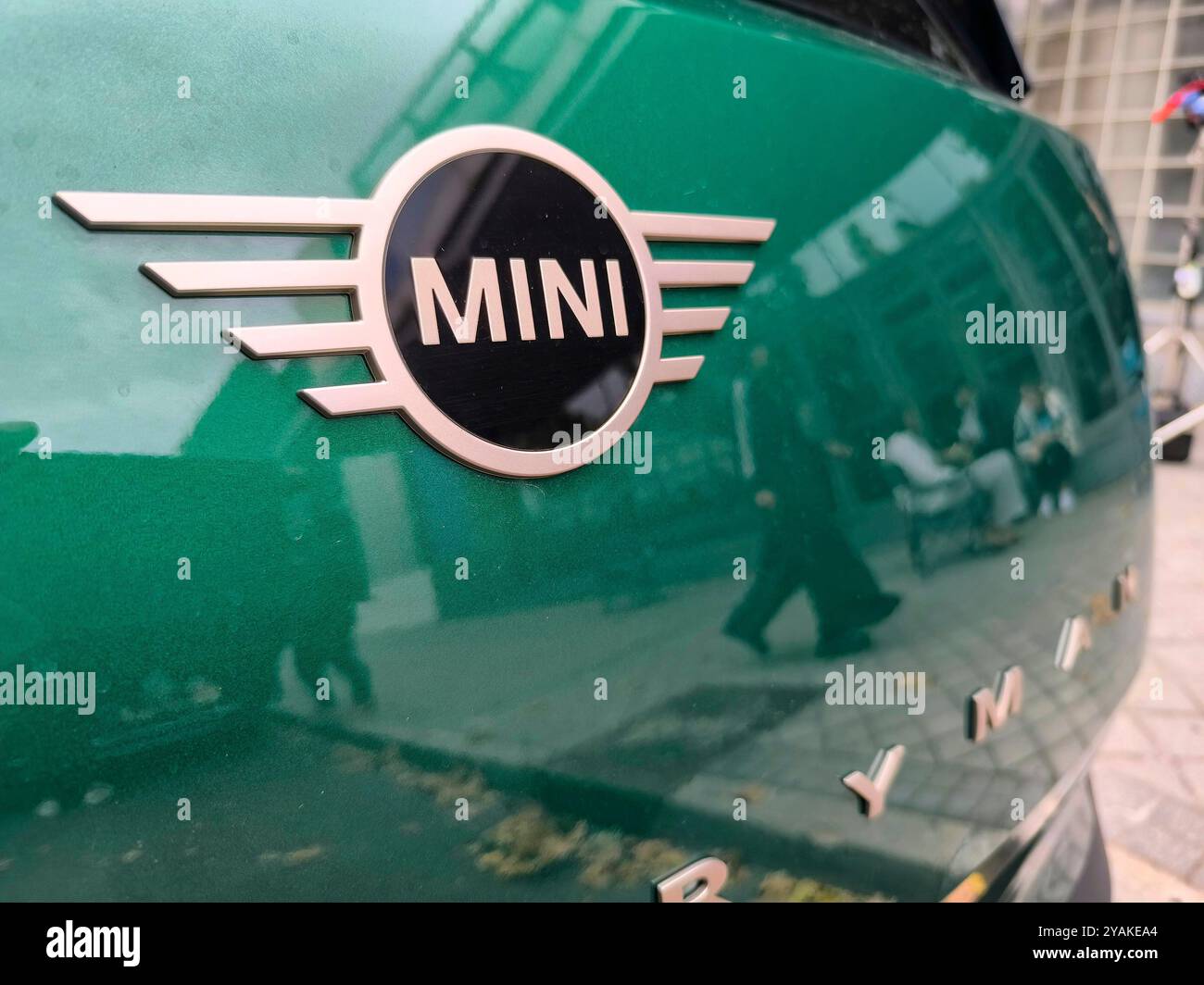 In the streets of Madrid, the logo of a Mini Countryman is photographed during an autumn day that highlights the green color of the car Stock Photo