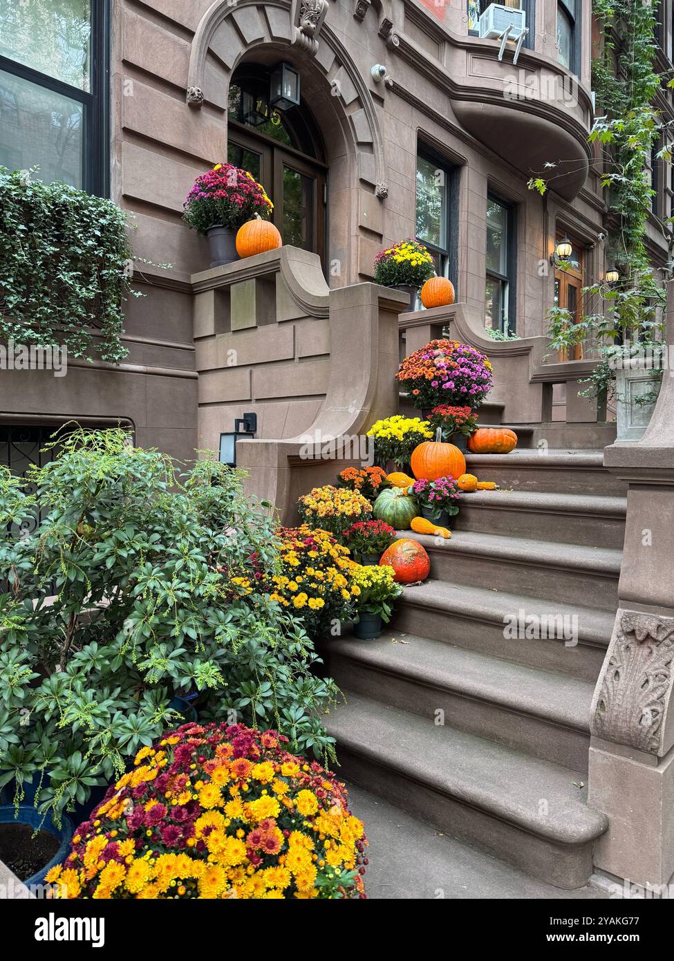 Halloween decorations on Brownstone apartment steps in Upper West Side district of Manhattan New York City NY USA October 2024 - Smartphone Captured Stock Image