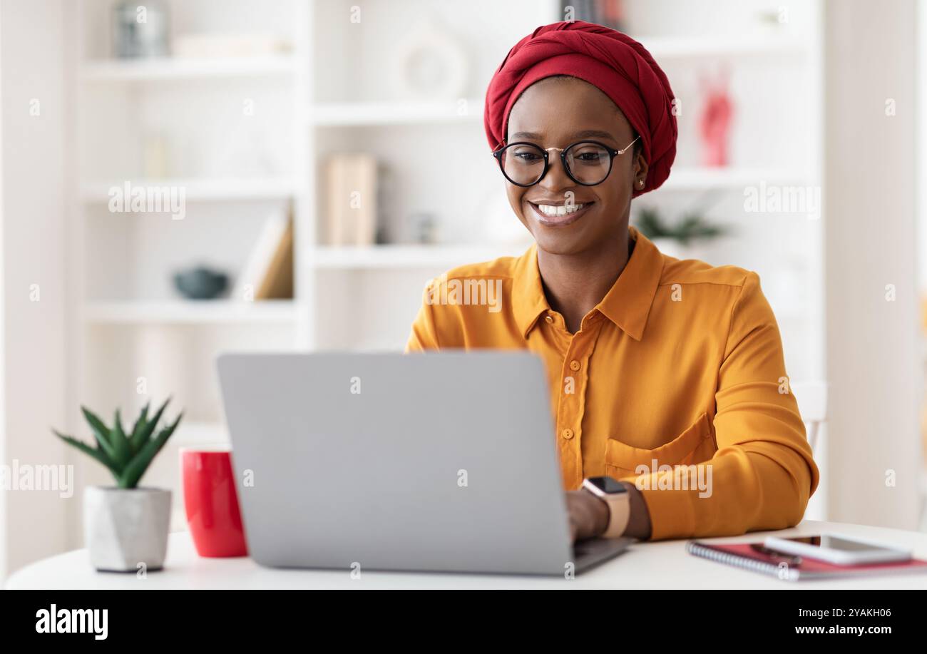 Cheerful millennial black woman entrepreneur working from home Stock ...