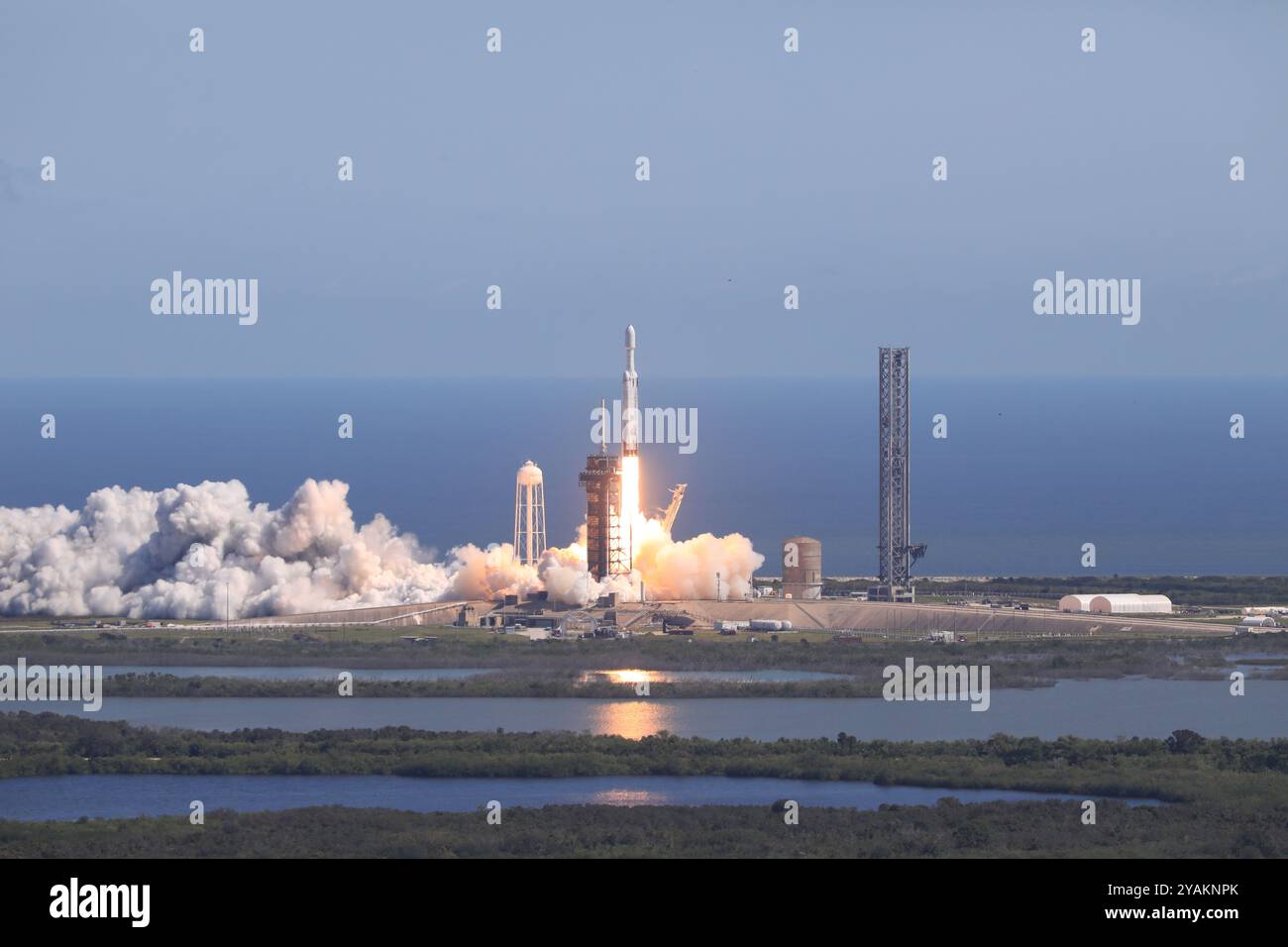 Cape Canaveral, United States of America. 14 October, 2024. A SpaceX Falcon Heavy rocket carrying the NASA Europa Clipper unmanned spacecraft blasts off from Launch Complex 39A at Kennedy Space Center, October 14, 2024 in Cape Canaveral, Florida. The spacecraft will explore the ice-covered Europa orbiting Jupiter in a search for life. Credit: Kim Shiflett/NASA Photo/Alamy Live News Stock Photo