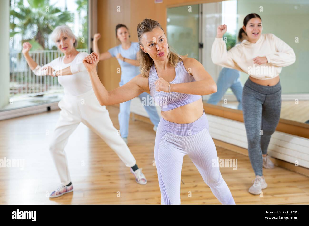 Group are practising arch movement in step jazz dance in fitness gym ...