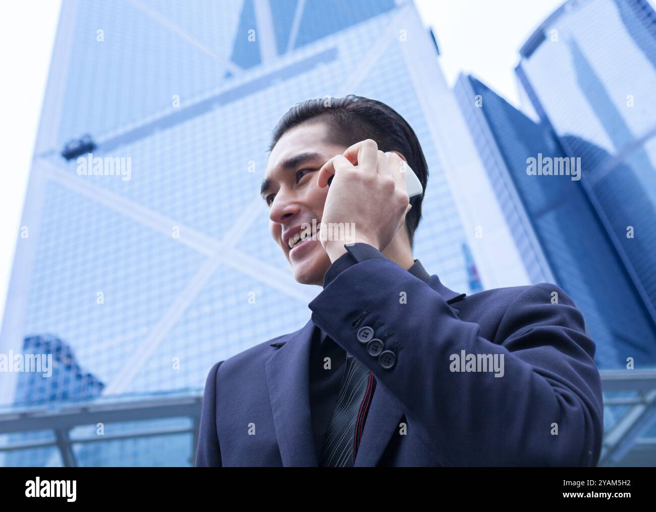Businessman talking on phone in the city. Stock Photo