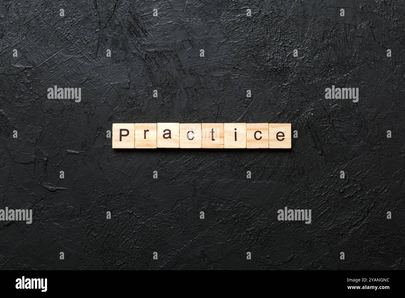 practice word written on wood block. practice text on table, concept. Stock Photo