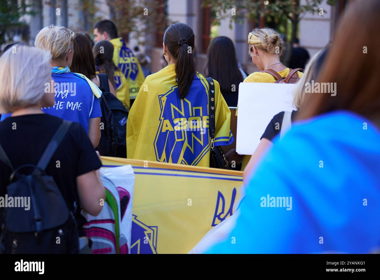 Ukrainian woman wearing Azov brigade flag on shoulders at public ...