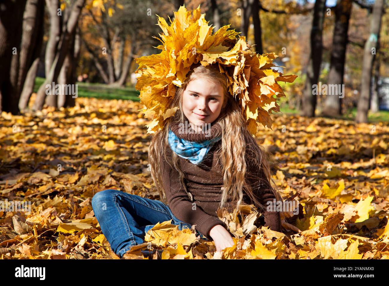 Portrait of beautiful little girl with autumn leaves Stock Photo - Alamy