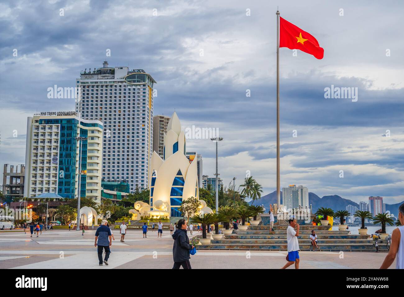 The flag of Vietnam on the flagpole and the Lotus Tower on the central