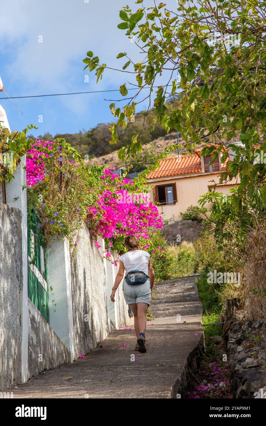 Woman  holidaymaker walking in the hills above the seaside resort of Machico the second largest resort on the Portuguese Island of Madeira Stock Photo