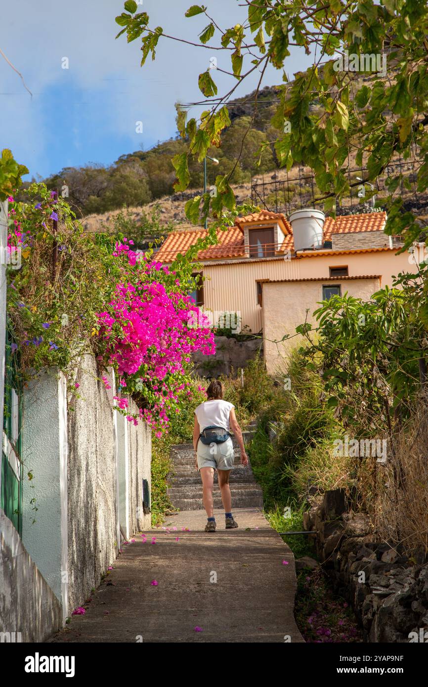 Woman  holidaymaker walking in the hills above the seaside resort of Machico the second largest resort on the Portuguese Island of Madeira Stock Photo