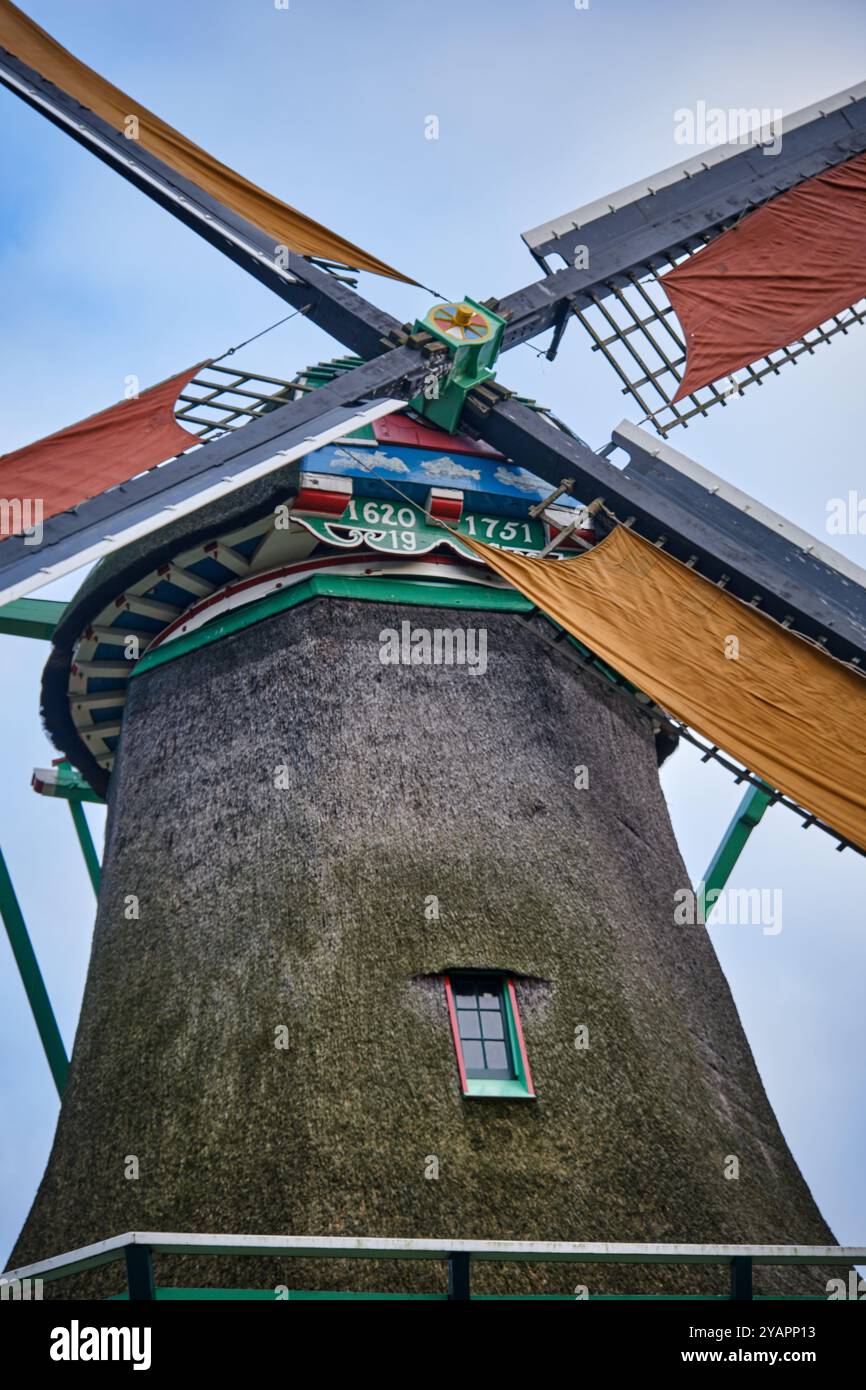 Close- up of working 17th century oilmill Het Pink (The Yearling) in Koog aan de Zaan with full winter sails under a overcast sky Stock Photo