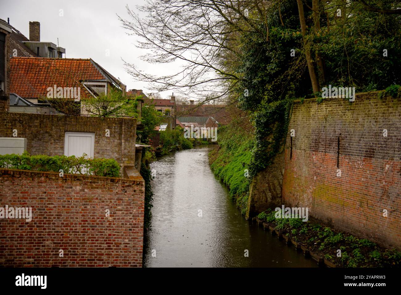 Bruges canal and brick canal wall, Belgium. Stock Photo