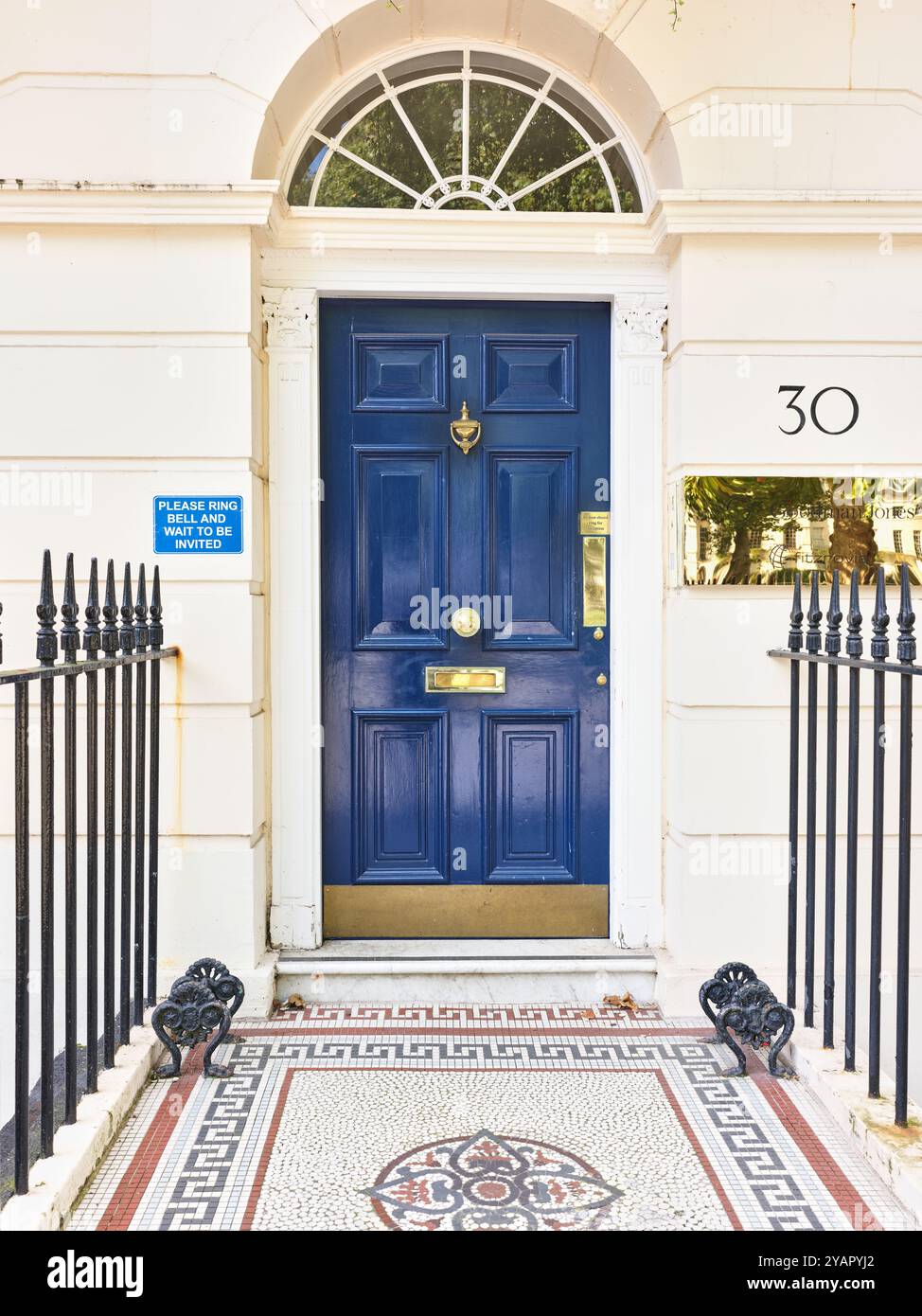 'Please ring bell and wait to be invited' notice at Goodman Jones, 30 Fitzroy Square, London, England. Stock Photo