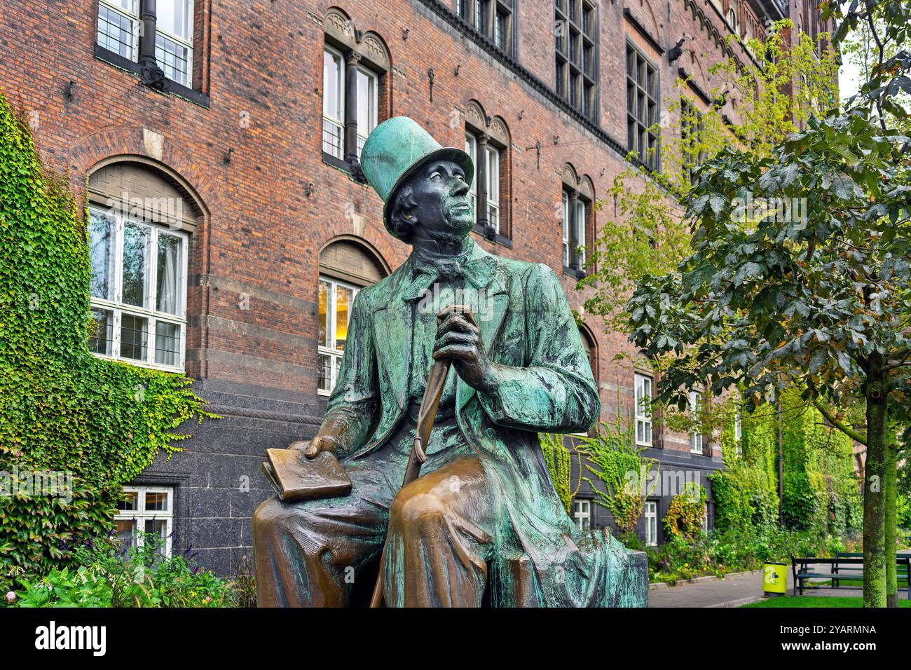 The statue of renowned Danish author Hans Christian Andersen sits outside Copenhagen City Hall, Denmark, symbolizing his legacy and contributions. Stock Photo