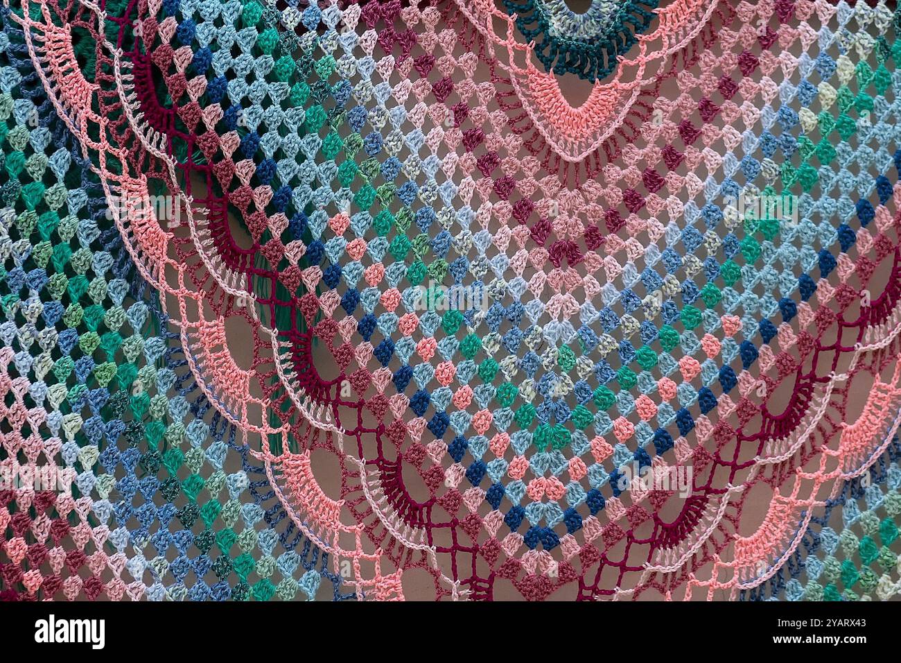 Handmade knitted shawl with a multi-colored pattern close-up Stock Photo